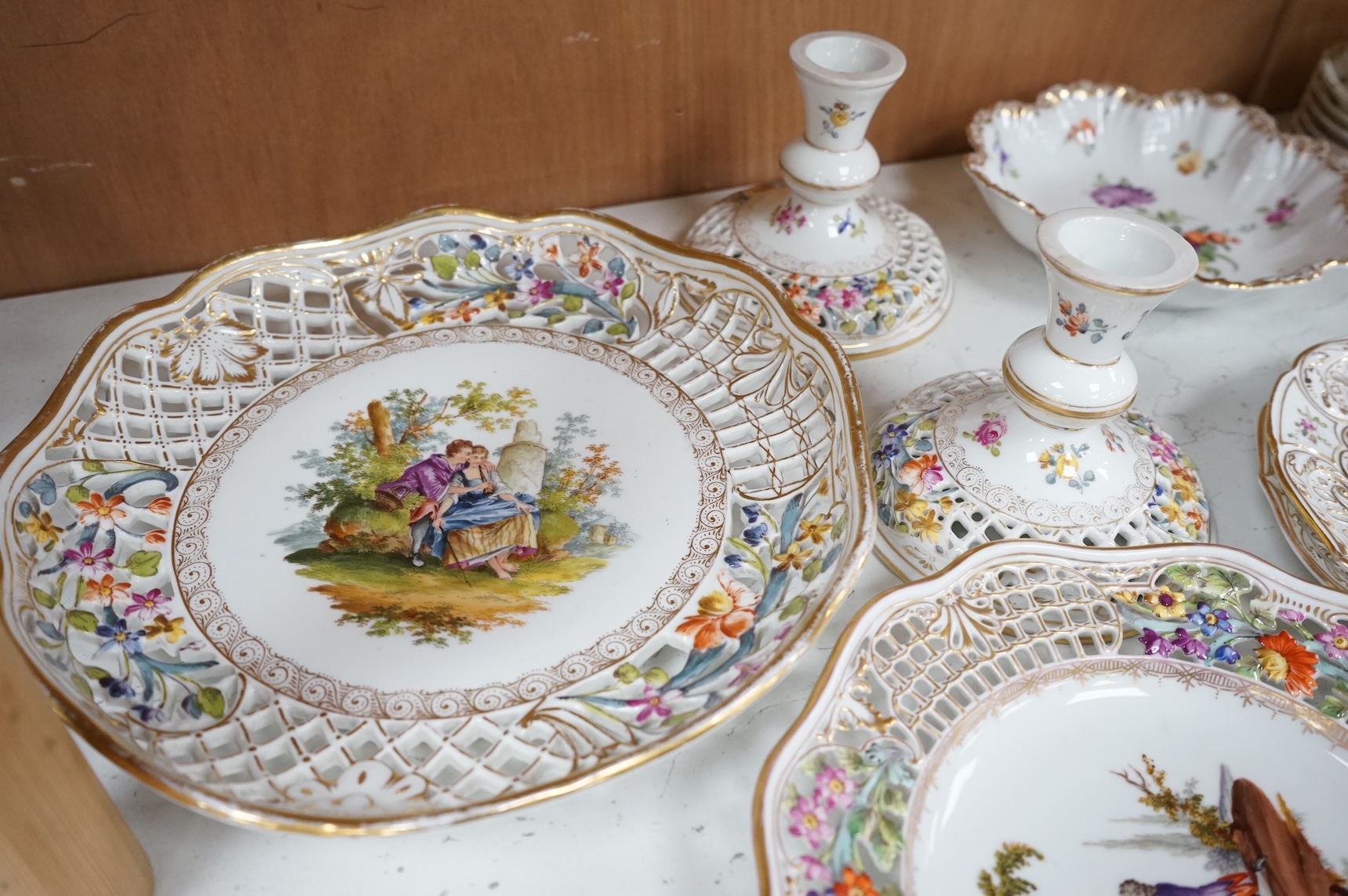 A Dresden porcelain part tea set together with reticulated side plates, largest 26cm in diameter
